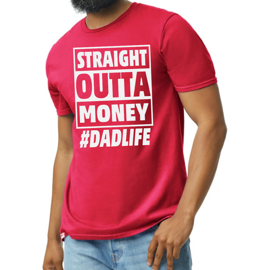 Image of a T-shirt with the phrase ‘Straight Out of Money #DadLife’ in bold, eye-catching lettering. The design humorously reflects the financial jest of fatherhood where dads spend generously on their kids. The shirt is displayed in multiple colors: black, red, yellow, gold, blue, and green, catering to various personal styles. This shirt offers both comfort and a funny twist on the everyday life of dads.