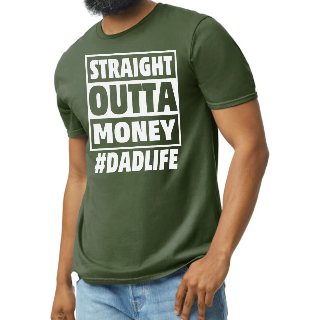 Image of a T-shirt with the phrase ‘Straight Out of Money #DadLife’ in bold, eye-catching lettering. The design humorously reflects the financial jest of fatherhood where dads spend generously on their kids. The shirt is displayed in multiple colors: black, red, yellow, gold, blue, and green, catering to various personal styles. This shirt offers both comfort and a funny twist on the everyday life of dads.