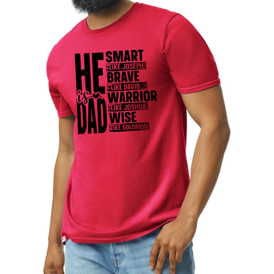 Image of a white T-shirt with the phrase ‘He Is Dad’ in bold, modern typography. Below the main text, the shirt features inspirational attributes linked to biblical figures: ‘Smart like Joseph,’ ‘Brave like David,’ ‘Warrior like Joshua,’ and ‘Wise like Solomon,’ each line styled to highlight these venerable qualities. The design is also available in red, black, and gray color options, visible in smaller images positioned beside the main white T-shirt.
