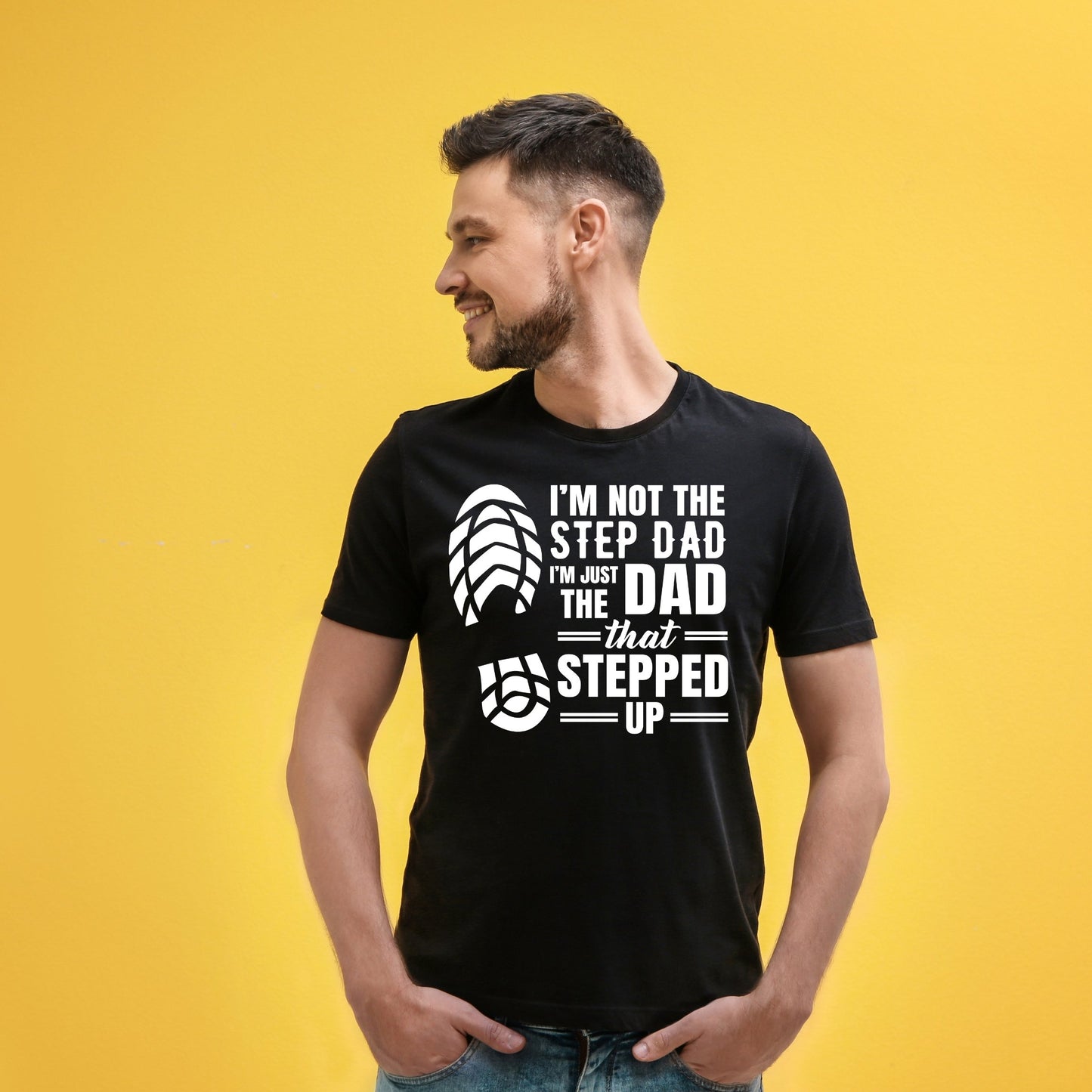 White or black tshirt with bold writing “im not the step dad, im the dad that stepped up and a foot print image near the font