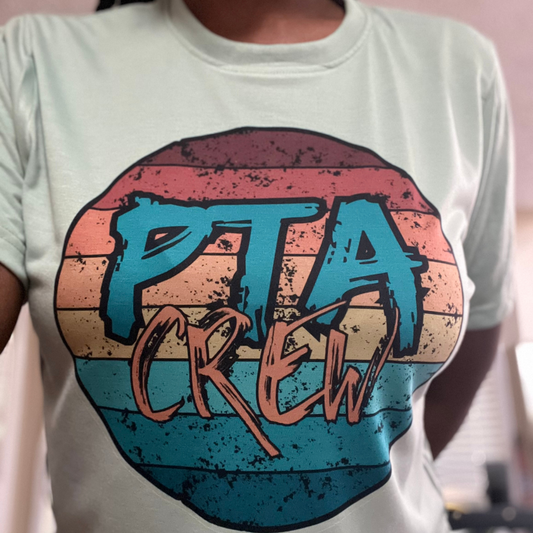 Unisex PTA Crew T-Shirt with a colorful grunge design and 'PTA Crew' lettering, available in various sizes and shirt colors