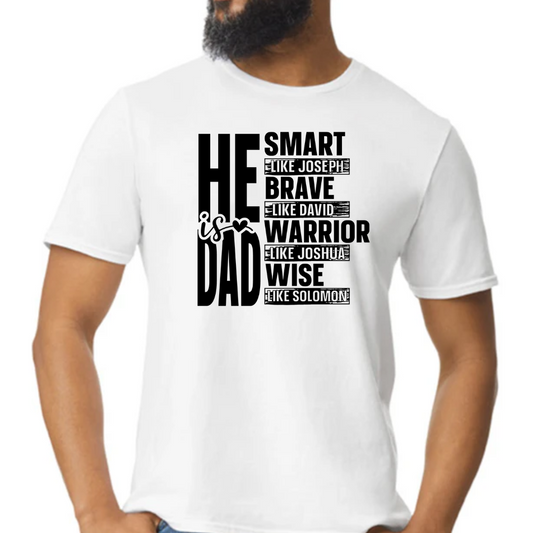 Image of a white T-shirt with the phrase ‘He Is Dad’ in bold, modern typography. Below the main text, the shirt features inspirational attributes linked to biblical figures: ‘Smart like Joseph,’ ‘Brave like David,’ ‘Warrior like Joshua,’ and ‘Wise like Solomon,’ each line styled to highlight these venerable qualities. The design is also available in red, black, and gray color options, visible in smaller images positioned beside the main white T-shirt.